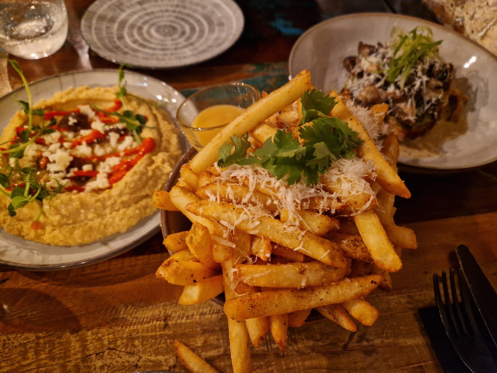 Shared dishes, hummus and fries at Pinocchio restaurant in Bergen